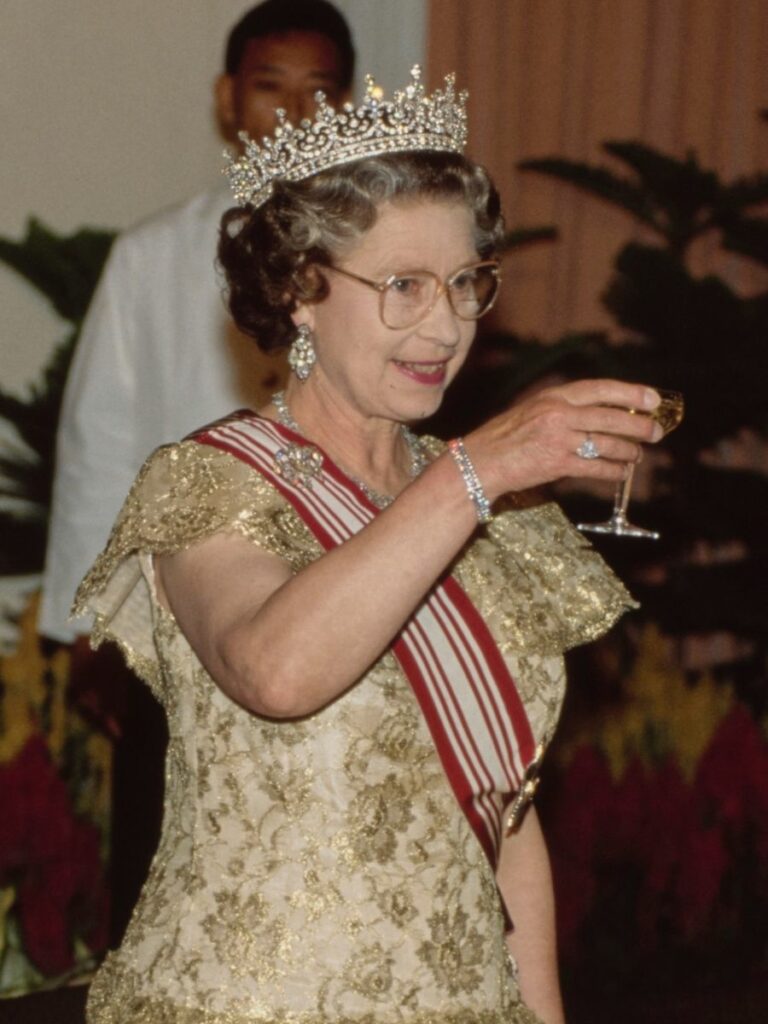 British Royal Queen Elizabeth II, wearing the Girls of Great Britain and Ireland diamond tiara, attend a State Banquet during the Queen's visit to Singapore, 10th October 1989